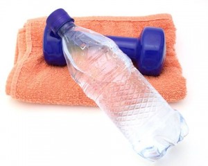 Photo of a weight, towel and bottle of water